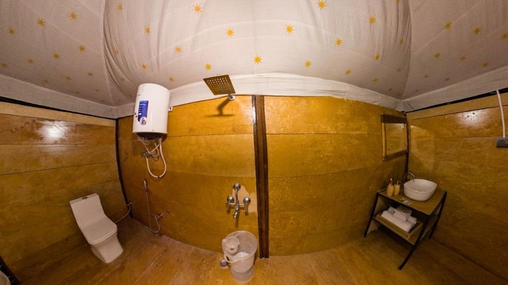 Attached washroom with modern fittings inside desert tent