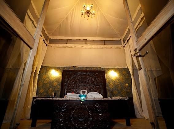 Canopy bed with chandelier in heritage tent