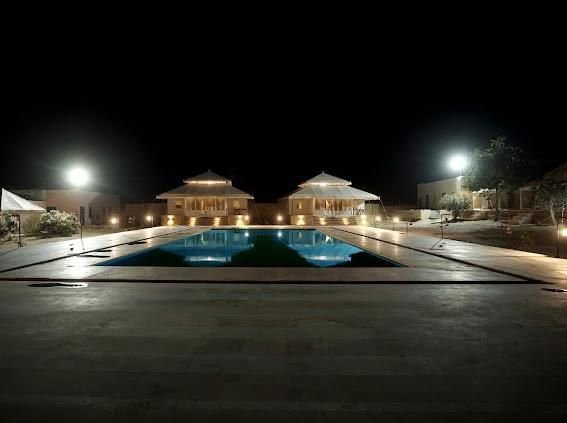 Pool and tents lit up at night
